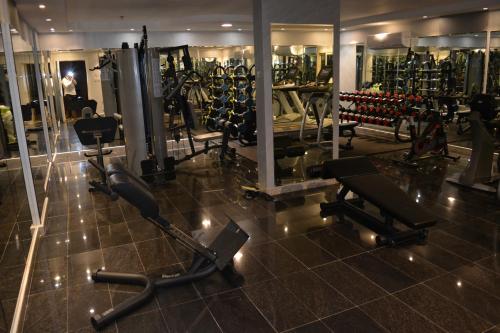 a gym with several treadmills and exercise bikes at Marina Palace Hotel in Al Madinah