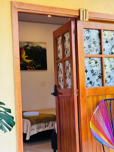 an open door to a room with a bedroom at Coffee House Minca in Minca