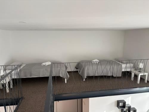 a room with two beds and a table at Jégmadár Vendégház in Baja