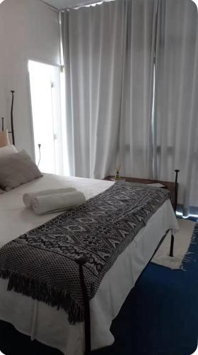 a bedroom with a large bed with a window at centro Historico Salvador in Salvador