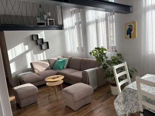 a living room with a couch and a table at Jégmadár Vendégház in Baja