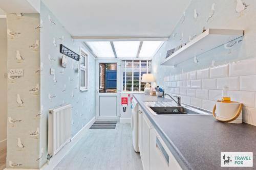 a kitchen with a sink and a counter top at Seagull Cottage in Hunstanton
