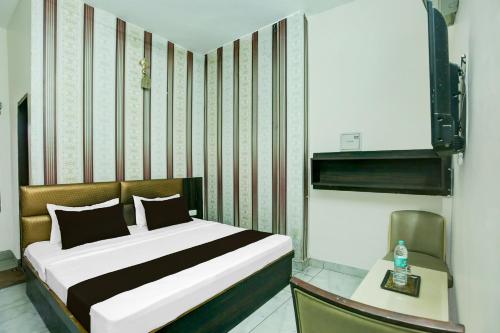 Ένα ή περισσότερα κρεβάτια σε δωμάτιο στο Hotel O J Classic