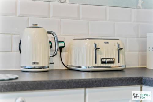 two toasters sitting on a counter in a kitchen at Seagull Cottage in Hunstanton