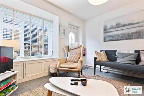 a living room with a couch and a tv at Seagull Cottage in Hunstanton