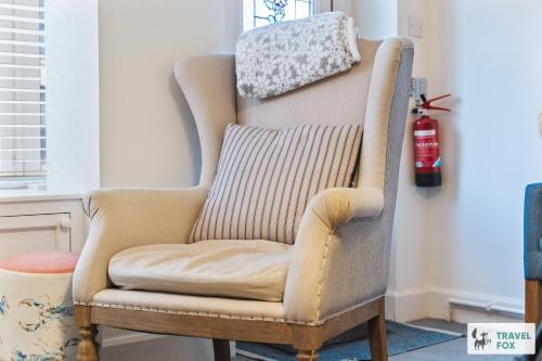 a chair with a pillow on top of it at Seagull Cottage in Hunstanton