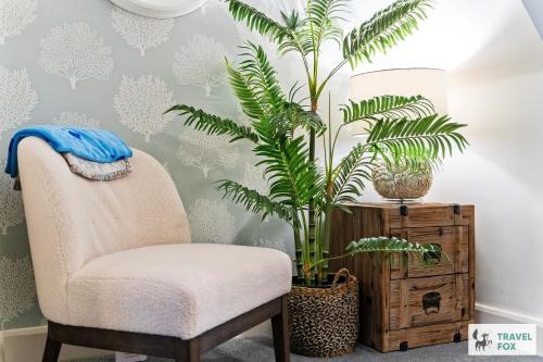 a chair and a plant in a room at Seagull Cottage in Hunstanton