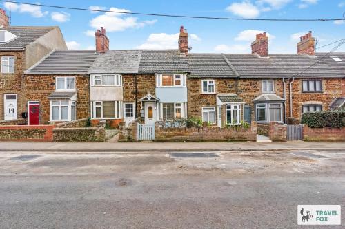 a row of brick houses on a street at Seagull Cottage in Hunstanton