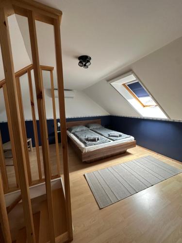 a bedroom with a bed in the attic at Heera Apartman in Hajdúszoboszló