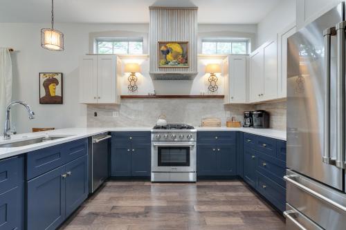 a kitchen with blue cabinets and a stove at Higbee House Too, AKA The Jolly Roger in Memphis