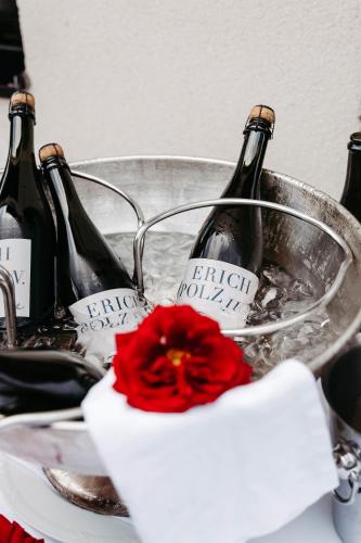 two bottles of wine in a bucket with a red flower at Hotel Brücklwirt in Niklasdorf