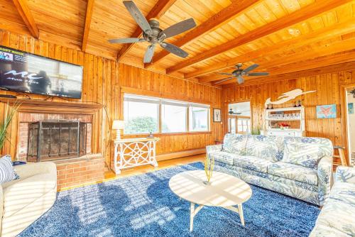 a living room with a couch and a fireplace at Gypsea Rose in Southern Shores