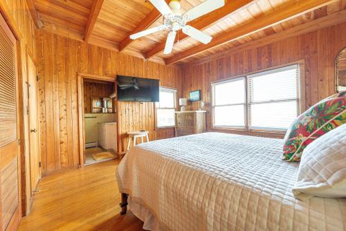a bedroom with a bed and a ceiling fan at Gypsea Rose in Southern Shores