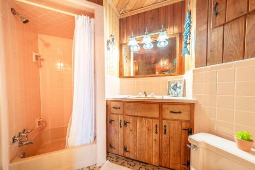 a bathroom with a sink toilet and a shower at Gypsea Rose in Southern Shores