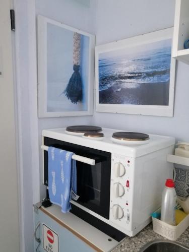 a kitchen with a microwave on a counter at Bluefullstop-Μπλε Τελεία in Artemida