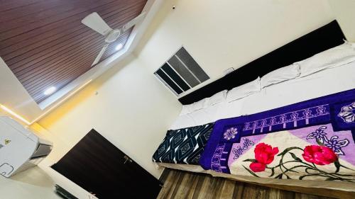 a room with two beds and a window at Shree nidhi comfort stay MAHAKAL ki krupa ujjain in Ujjain