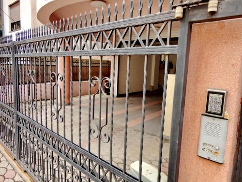 a metal gate in front of a building at Villa LD in Skopje