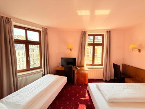 Ένα ή περισσότερα κρεβάτια σε δωμάτιο στο Hotel Merseburger Hof