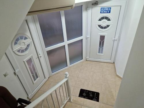 a staircase leading to a door with a sign on it at Villa LD in Skopje