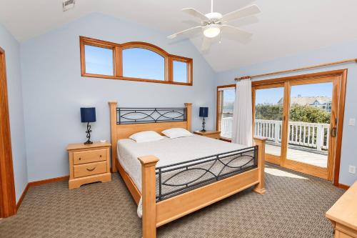 a bedroom with a bed and a balcony at Semi-Oceanfront, Priv Pool, Hot Tub, ELEV, Rec Rm-WL980, OBX Beach Bliss in Corolla