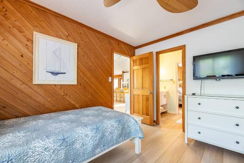 a bedroom with a bed and a flat screen tv at High Tides - D3850 in Duck