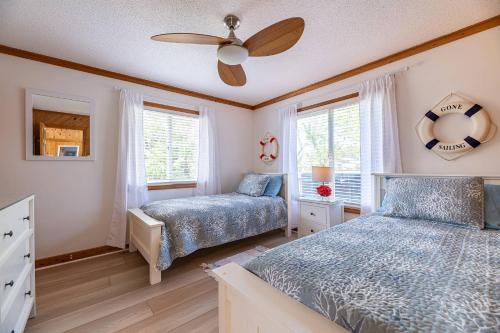a bedroom with two beds and a ceiling fan at High Tides - D3850 in Duck