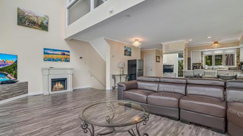 a living room with a couch and a fireplace at The Best Views From Camelback in Tannersville