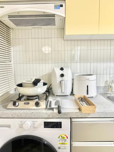 a kitchen with a counter top with a mixer and appliances at Konkuk Univ 2BR Cozy Apartment near Subway in Seoul
