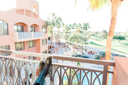 a person standing on a balcony looking out at a resort at Scottsdale Marriott at McDowell Mountains in Scottsdale