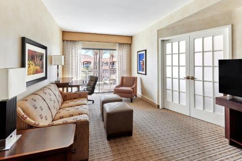 a living room with a couch and a tv at Scottsdale Marriott at McDowell Mountains in Scottsdale