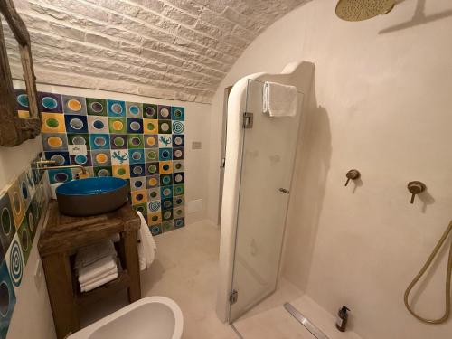a bathroom with a shower and a toilet at Trulli Terra Magica in Putignano