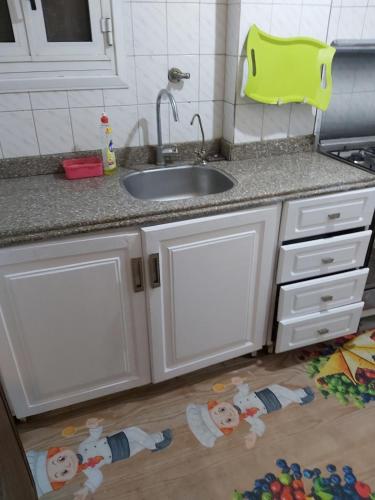a kitchen with a sink and some toys on the floor at Dokki private home and GYM in Cairo