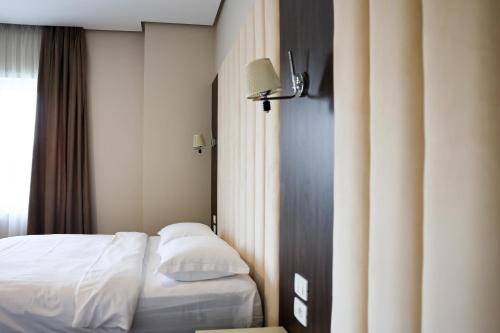 Postel nebo postele na pokoji v ubytování Gardenland Resort