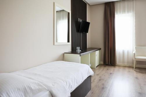 Postel nebo postele na pokoji v ubytování Gardenland Resort