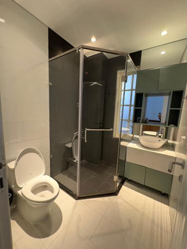 a bathroom with a toilet and a shower and a sink at Hoshi Dalat Fullhouse in Xuan An