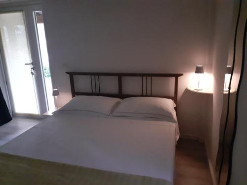 a bedroom with a bed with two pillows and a lamp at B&B Al Castagneto in Valmontone
