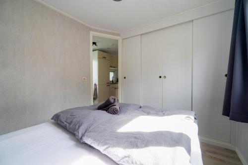 a bedroom with a bed with a purple stuffed animal on it at De Eik in Putten