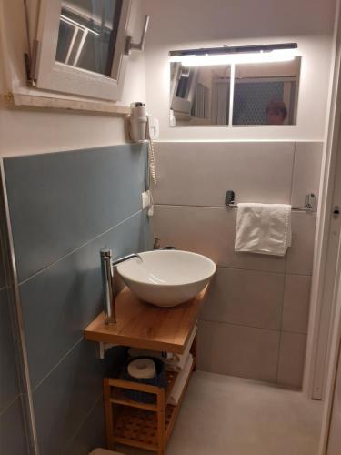 a small bathroom with a sink and a mirror at B&B Al Castagneto in Valmontone