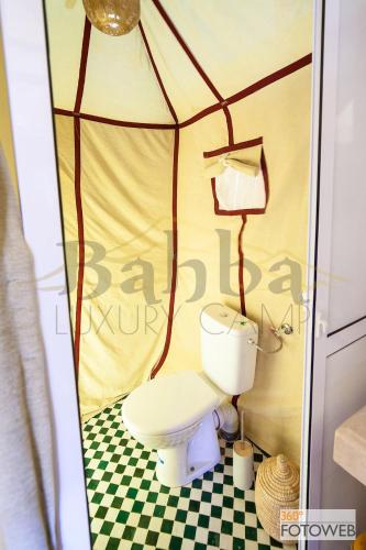 a bathroom with a toilet in a tent at Sahara Happy Camp in Merzouga