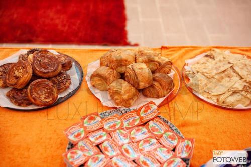 three plates of pastries and crackers on a table at Sahara Happy Camp in Merzouga