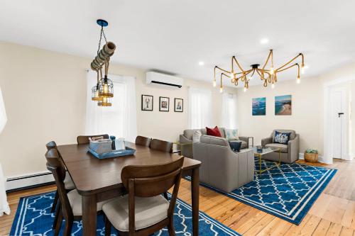 a dining room and living room with a table and chairs at The Seafarers Stay A Nautically Themed 3BR Flat in Stonington Borough in Stonington
