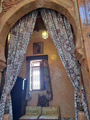 a living room with a window and a couch at Dar Si hmed in Rabat