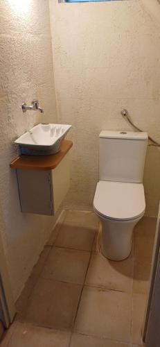 a bathroom with a toilet and a sink at חווה של דני in Bet Hillel