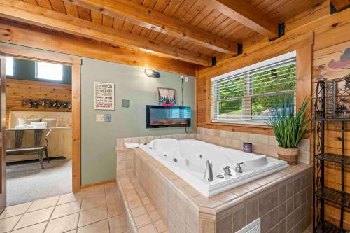 a large bathroom with a tub in a house at Log Home on Williamstown Lake - Near Ark in Dry Ridge