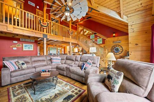 a large living room with couches and a ceiling at Log Home on Williamstown Lake - Near Ark in Dry Ridge