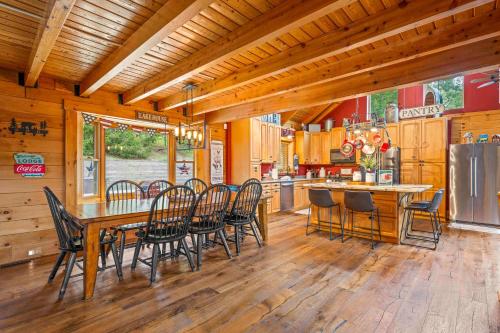 a dining room and kitchen with a table and chairs at Log Home on Williamstown Lake - Near Ark in Dry Ridge