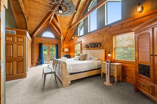 a bedroom with a bed in a wooden room at Log Home on Williamstown Lake - Near Ark in Dry Ridge