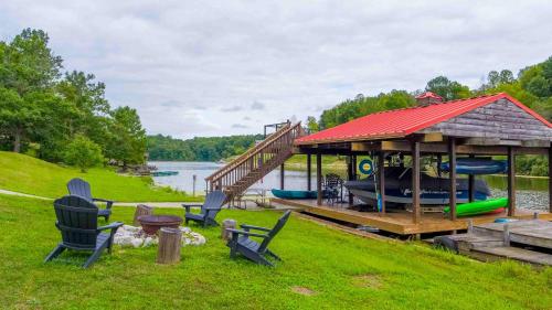 a gazebo with a playground next to a lake at Log Home on Williamstown Lake - Near Ark in Dry Ridge