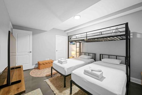 a bedroom with two beds and a loft bed at The City Staycation Condo - Downtown Cincy Views in Covington