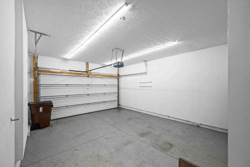 an empty garage with white walls and ceilings at The City Staycation Condo - Downtown Cincy Views in Covington